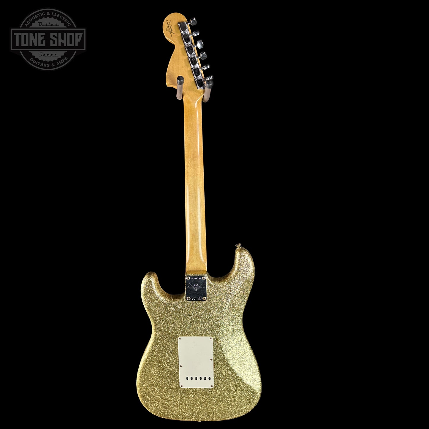 Gold glitter electric guitar on a black background with 'Tone Shop' logo.
