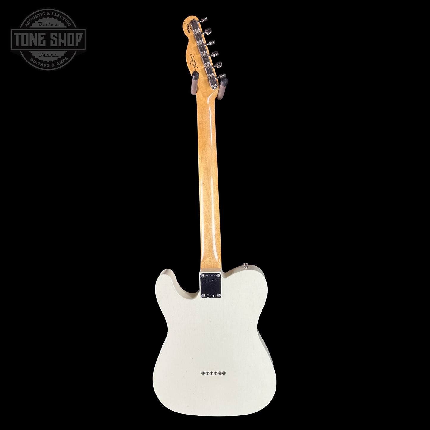 White electric guitar with a black background