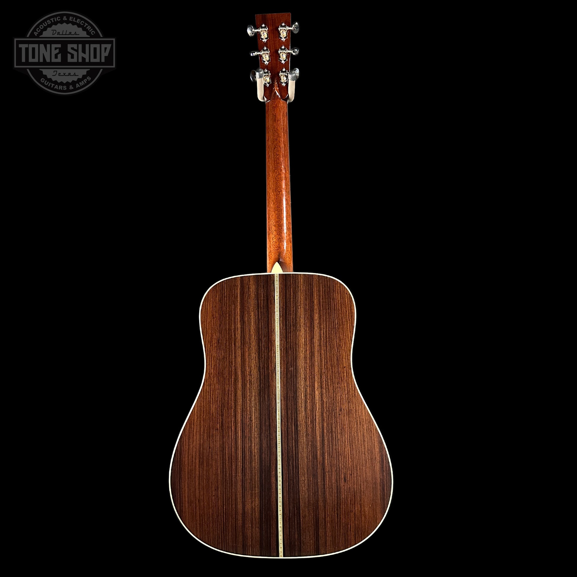 Back view of a wooden acoustic guitar on a black background with 'Tone Shop' logo.