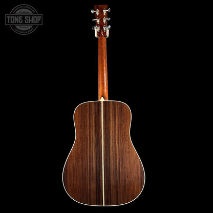 Back view of a wooden acoustic guitar on a black background with 'Tone Shop' logo.