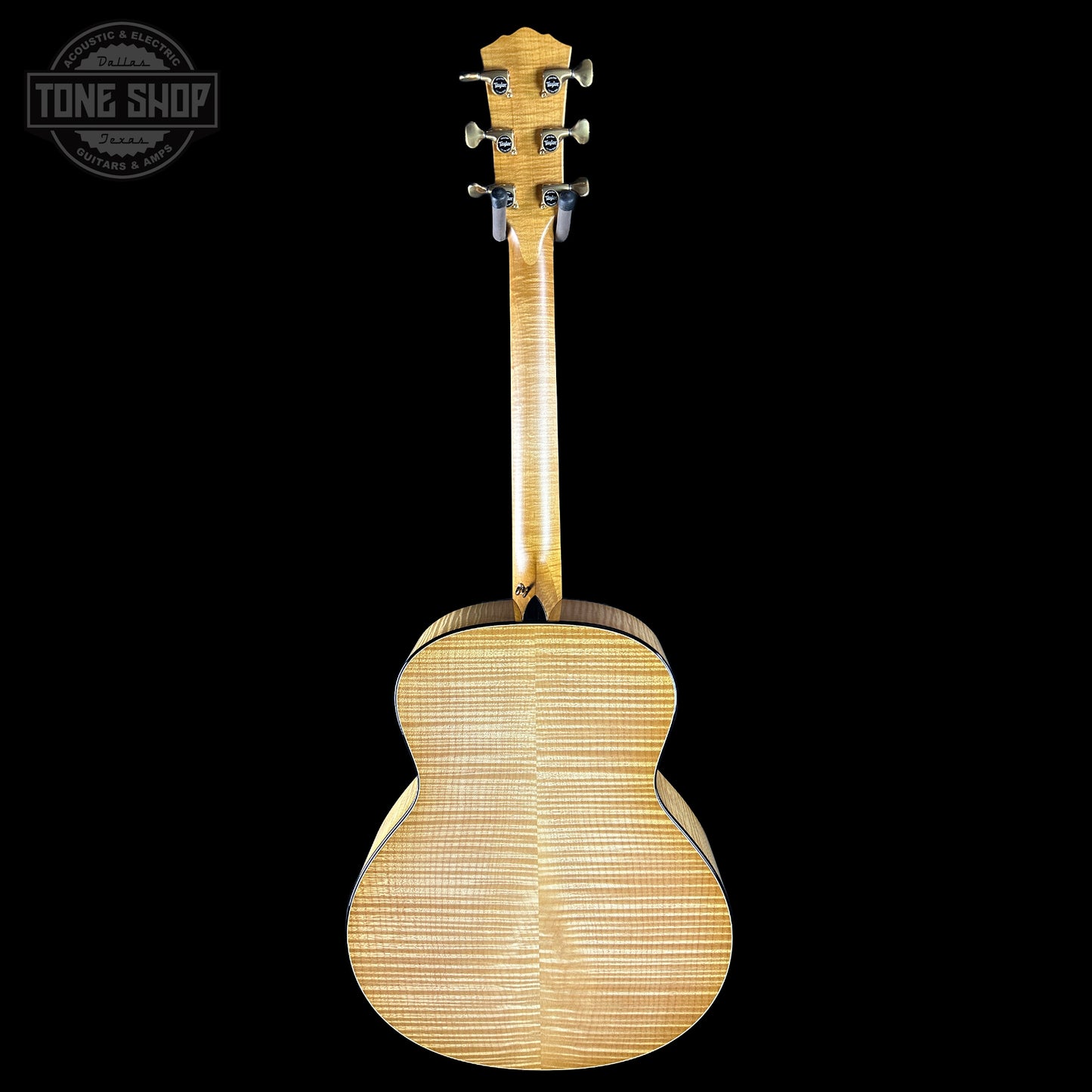 Back view of a wooden acoustic guitar on a black background with 'Tone Shop' logo.