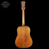 Back view of a wooden acoustic guitar with 'Tone Shop' logo in the corner.