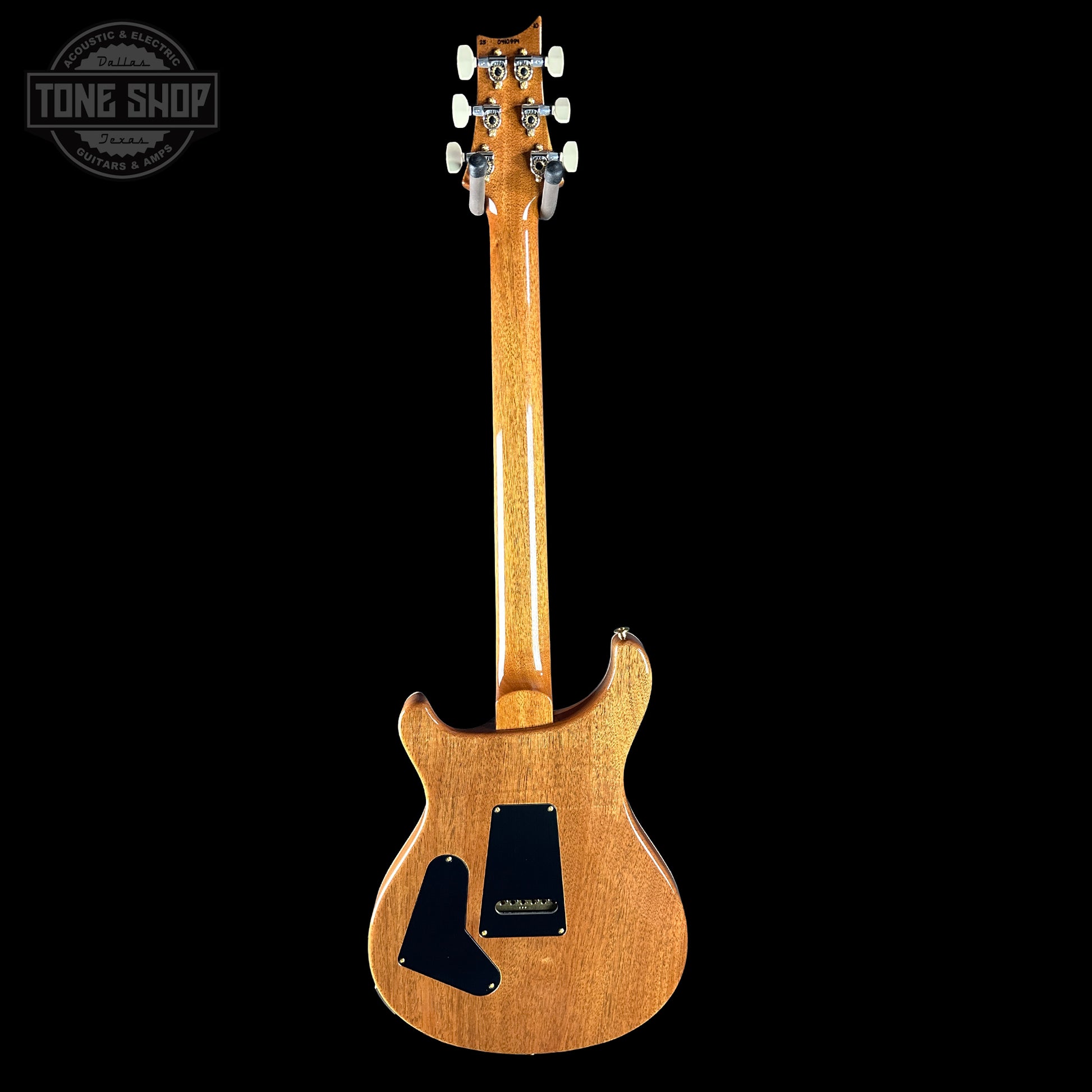 Electric guitar with a wooden body and neck on a black background, featuring the Tone Shop logo.