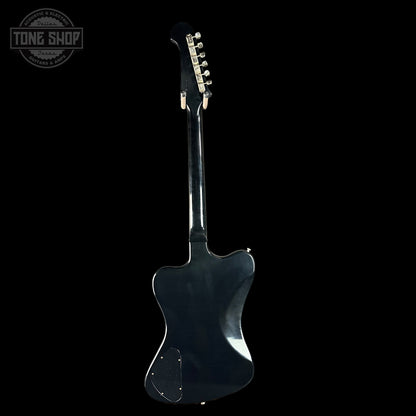 Black electric guitar on a black background with 'Tone Shop' logo.