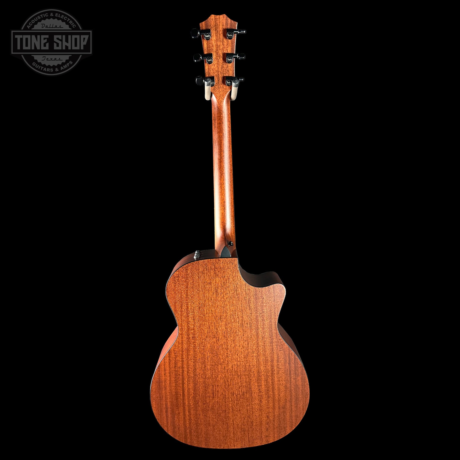 Back view of a wooden acoustic guitar with 'Tone Shop' logo in the corner.