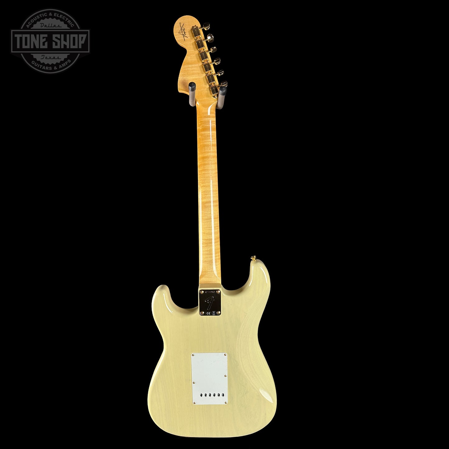 Beige electric guitar on a black background with 'Tone Shop' logo.