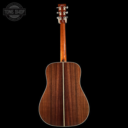 Back view of a wooden acoustic guitar with 'Tone Shop' logo in the corner.