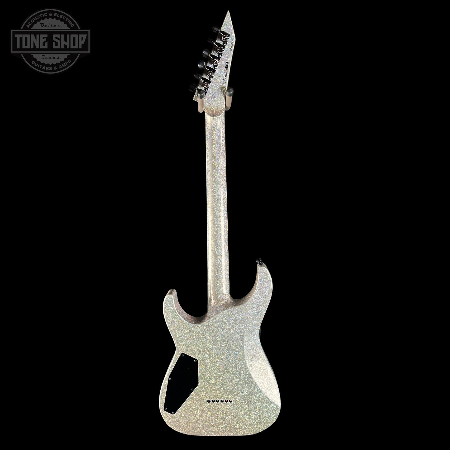Silver electric guitar with unique design on a black background