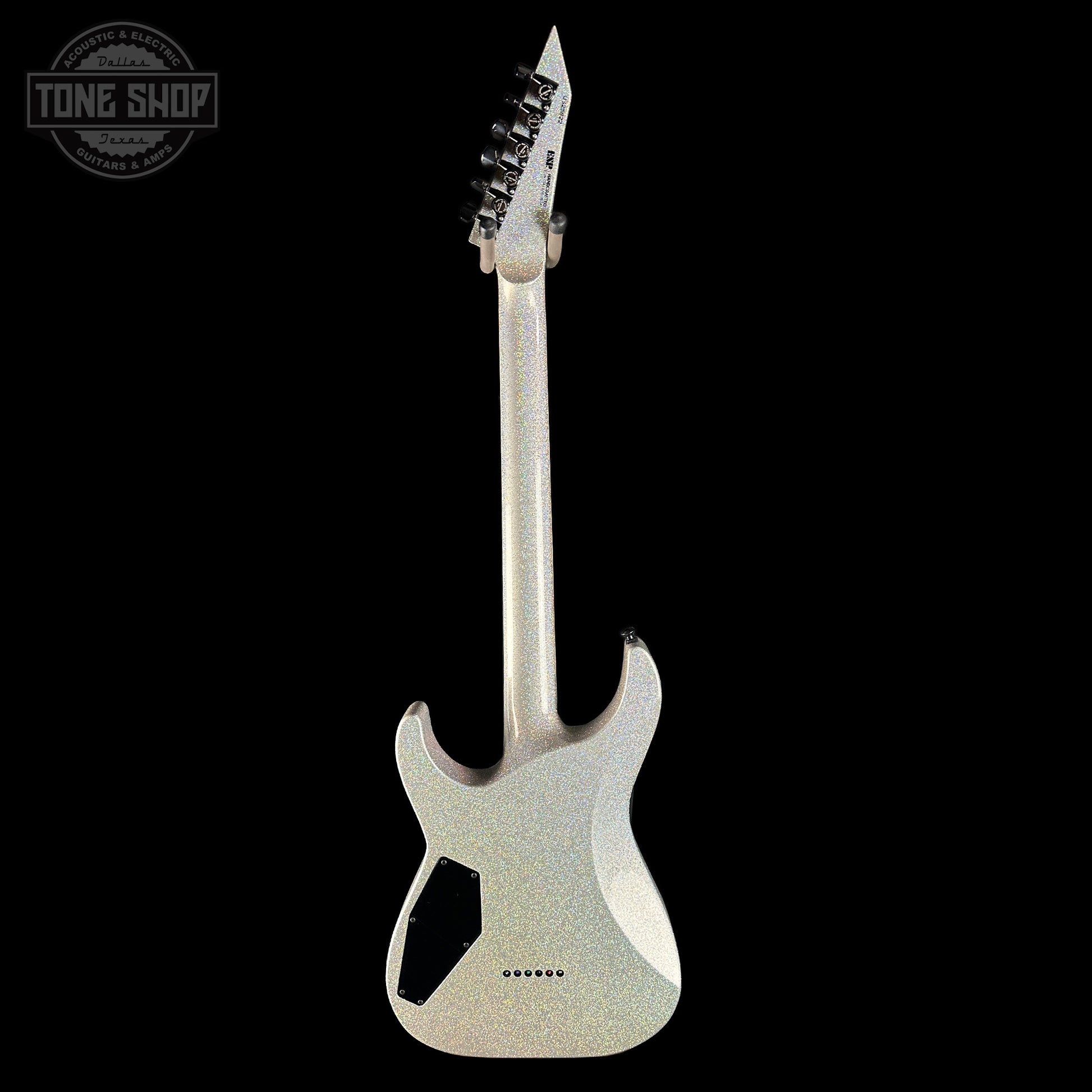 Silver electric guitar with unique design on a black background
