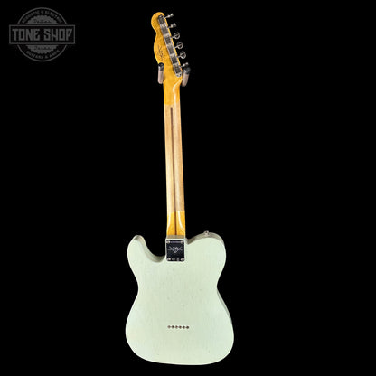 Electric guitar with a light-colored body and dark neck on a black background, featuring 'Tone Shop' logo.