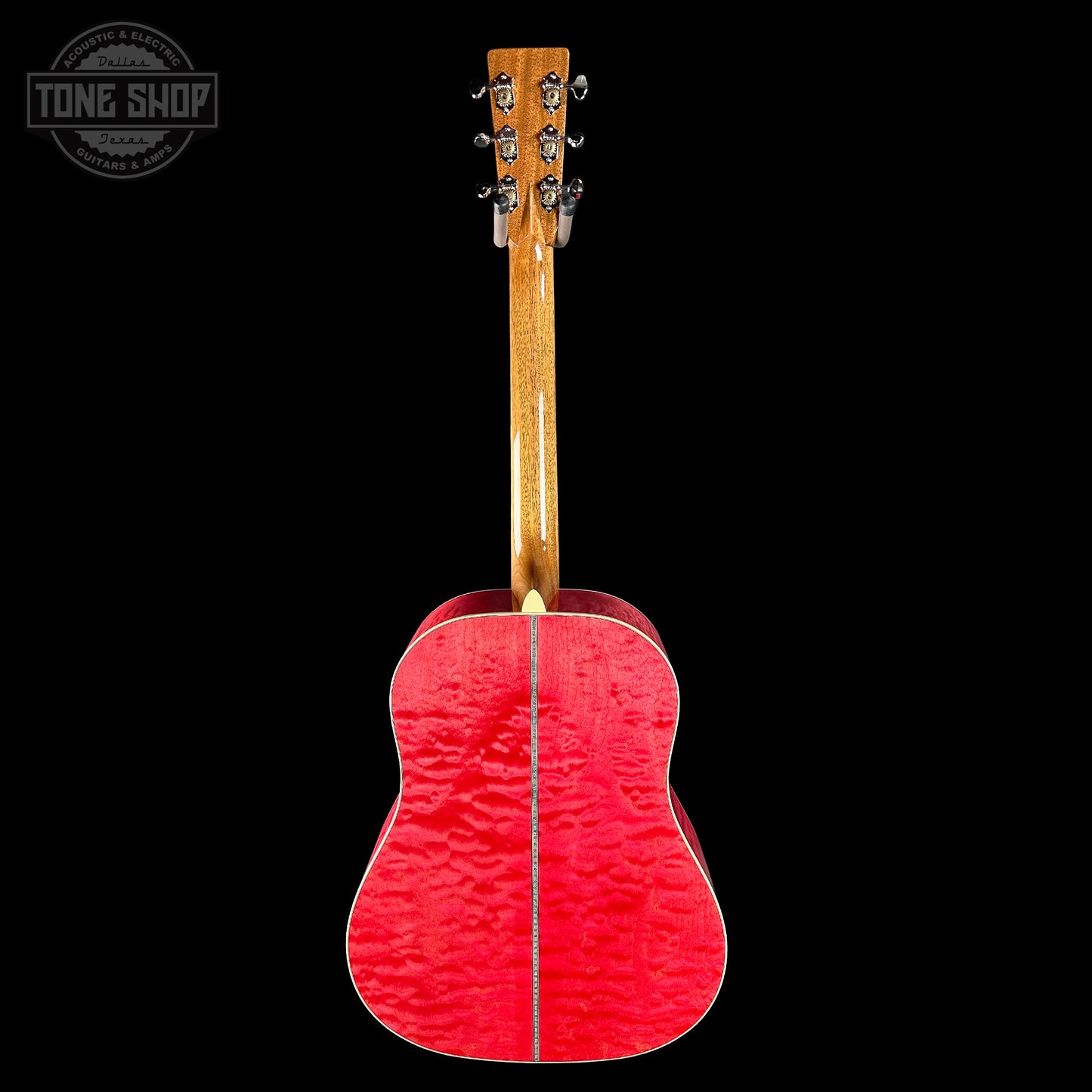 Red acoustic guitar with a black background