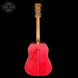 Red acoustic guitar with a black background