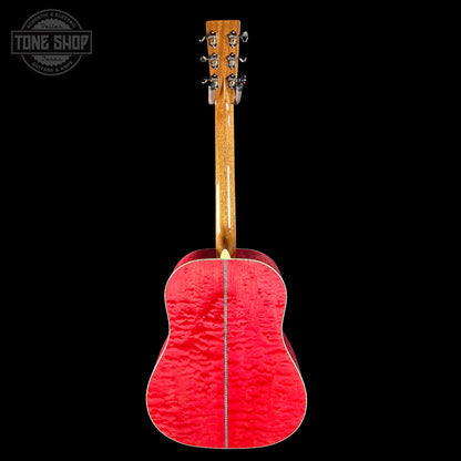 Red acoustic guitar with a black background