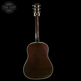 Back view of an acoustic guitar with a dark brown finish on a black background, featuring the Tone Shop logo.