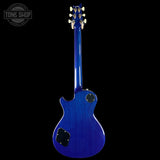 Blue electric guitar on a black background with 'Tone Shop' logo.