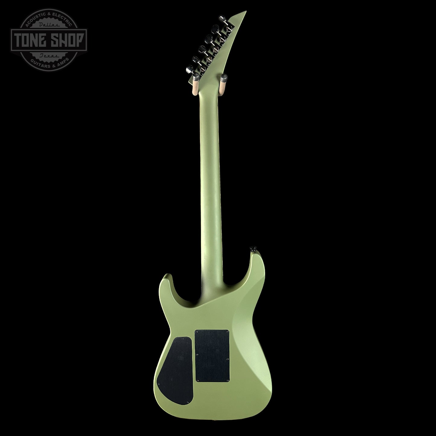 Green electric guitar on a black background with 'Tone Shop' logo.
