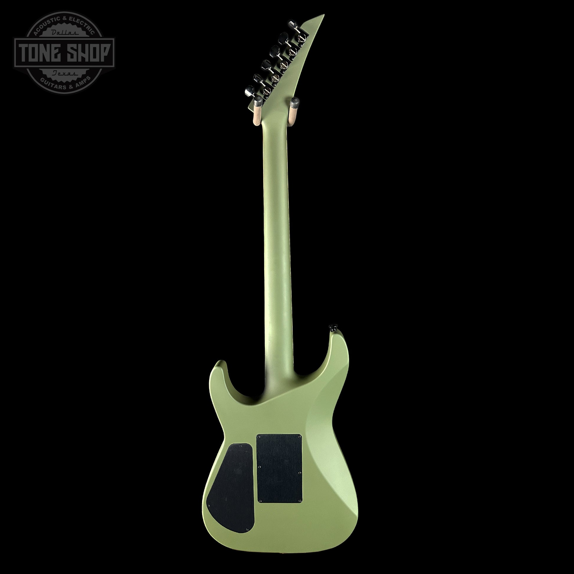 Green electric guitar on a black background with 'Tone Shop' logo.