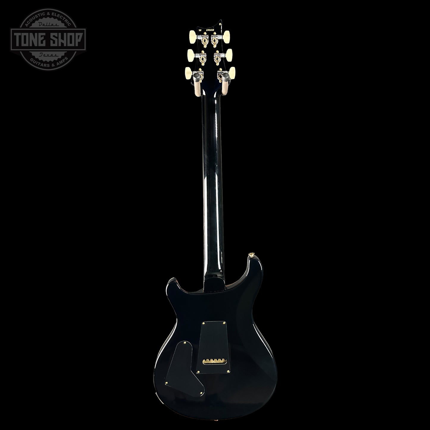 Black electric guitar on a white background with 'Tone Shop' logo.