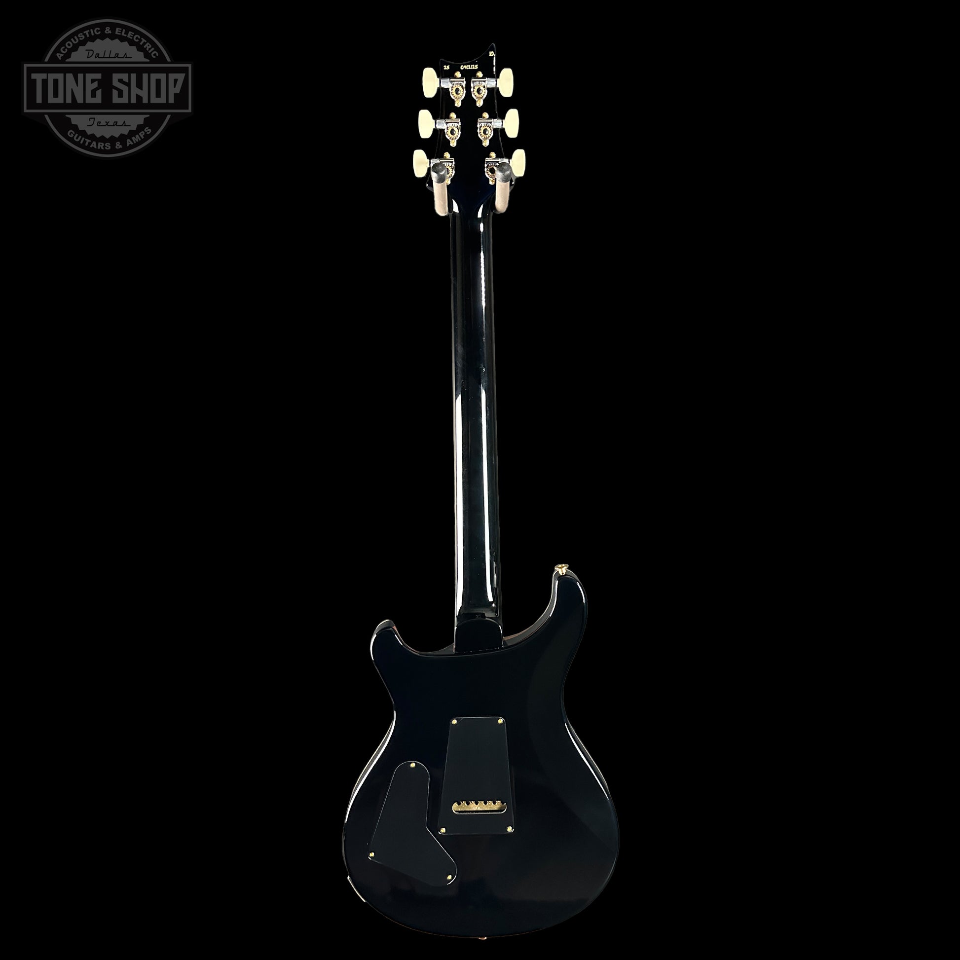 Black electric guitar on a white background with 'Tone Shop' logo.