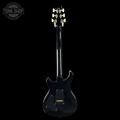 Black electric guitar on a white background with 'Tone Shop' logo.
