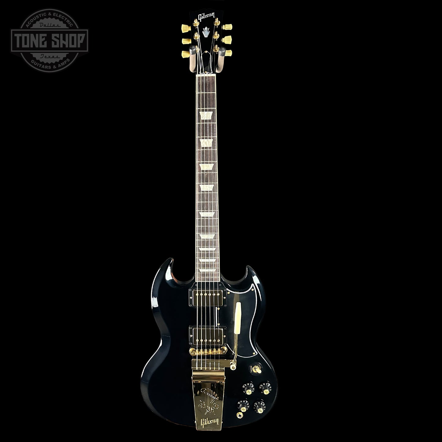 Black electric guitar with gold hardware on a black background, featuring the Gibson logo.
