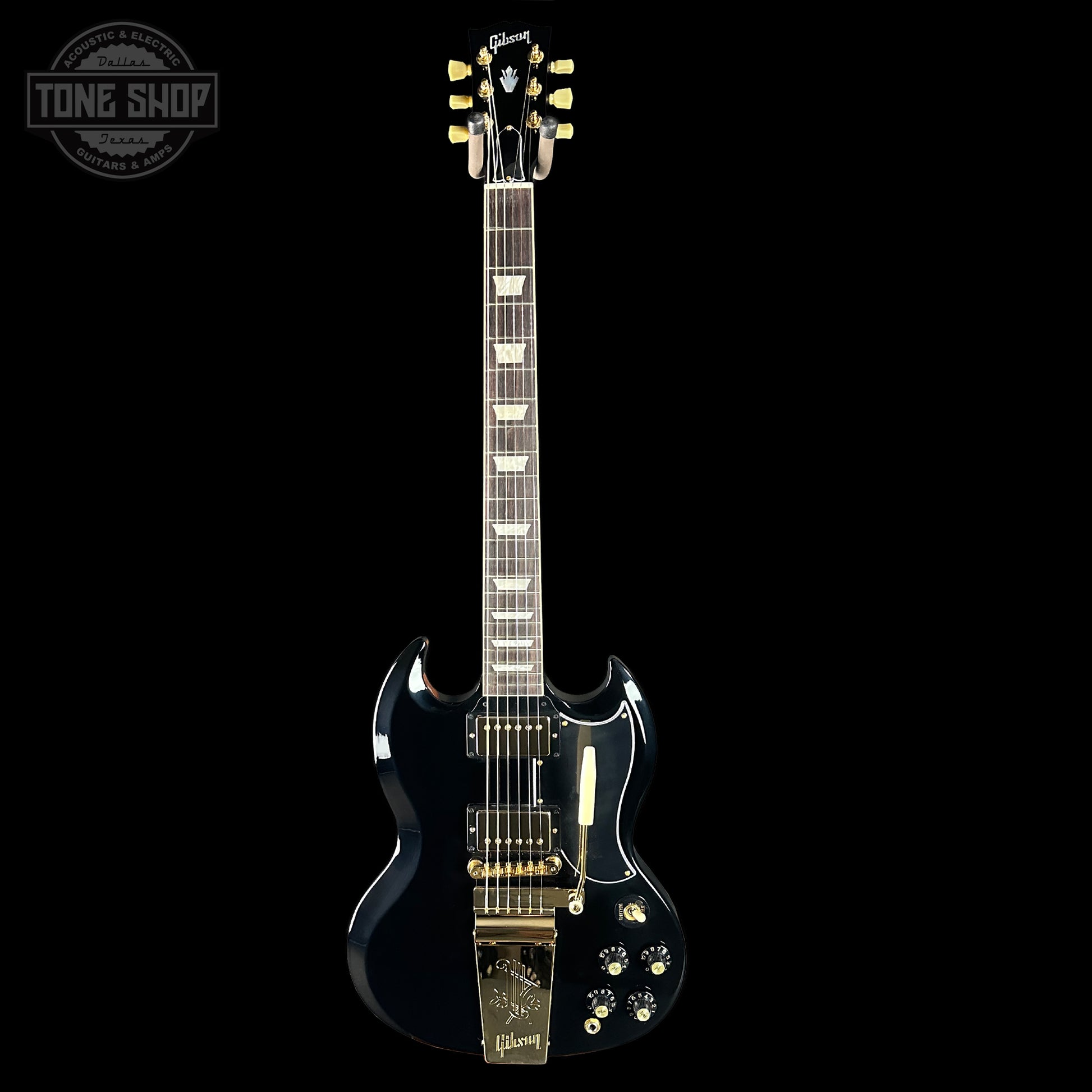 Black electric guitar with gold hardware on a black background, featuring the Gibson logo.
