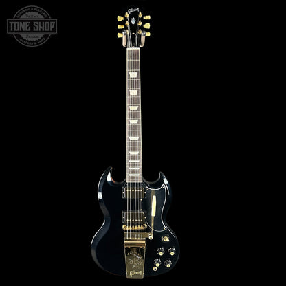 Black electric guitar with gold hardware on a black background, featuring the Gibson logo.