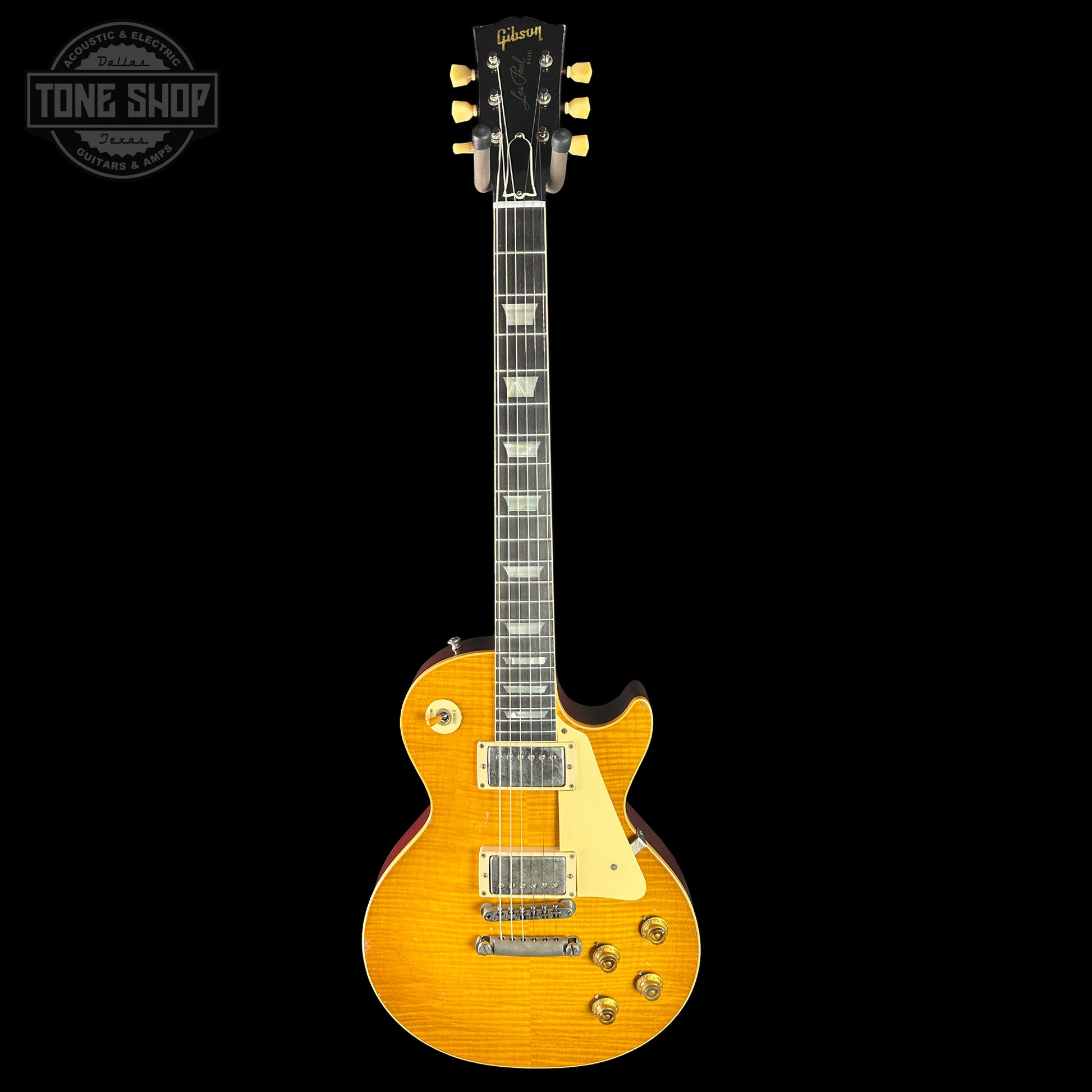Gibson Les Paul electric guitar with a sunburst finish on a black background, featuring the Tone Shop logo.