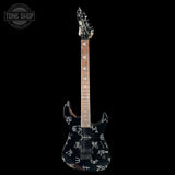 Electric guitar with black and white design on a black background, featuring 'Tone Shop' logo.