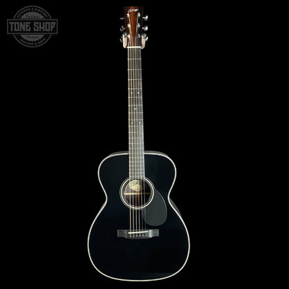 Black acoustic guitar on a black background with 'Tone Shop' logo.