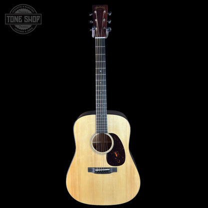 Acoustic guitar with a visible brand logo on a black background