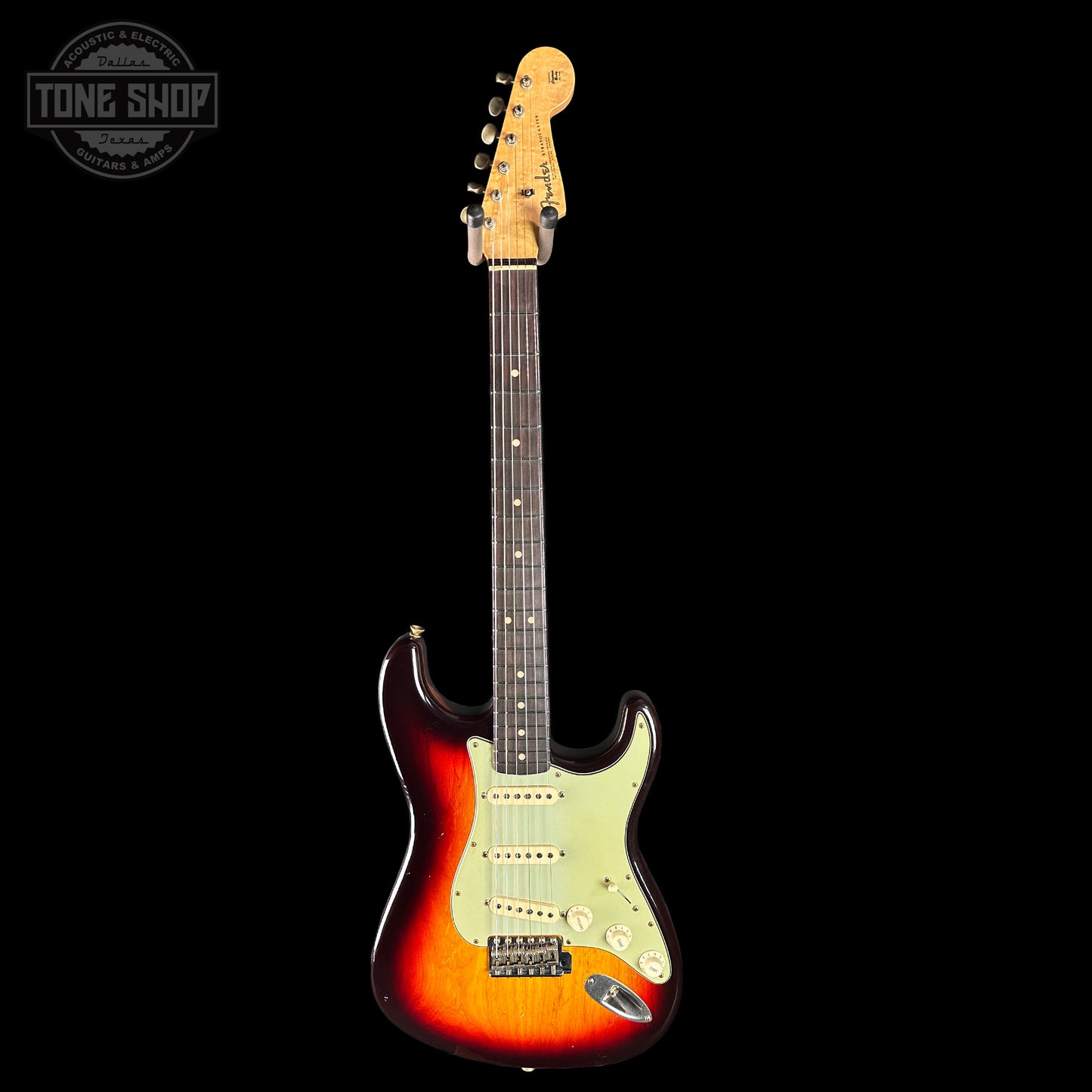 Electric guitar with a sunburst finish on a black background, featuring the Tone Shop logo.