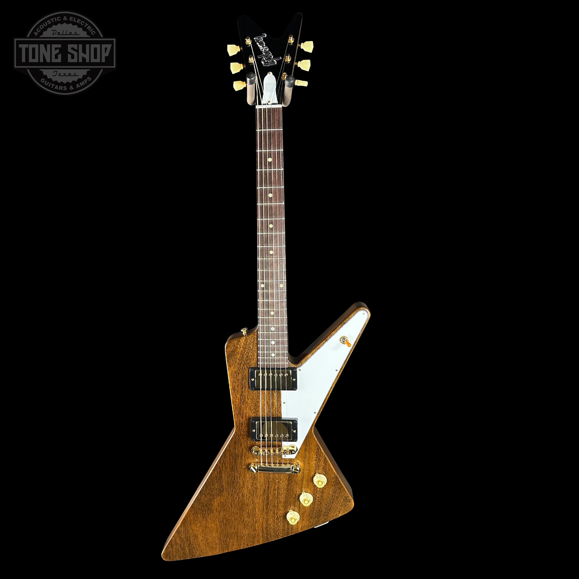 Gibson Explorer electric guitar with a wood finish on a black background, featuring the Tone Shop logo.