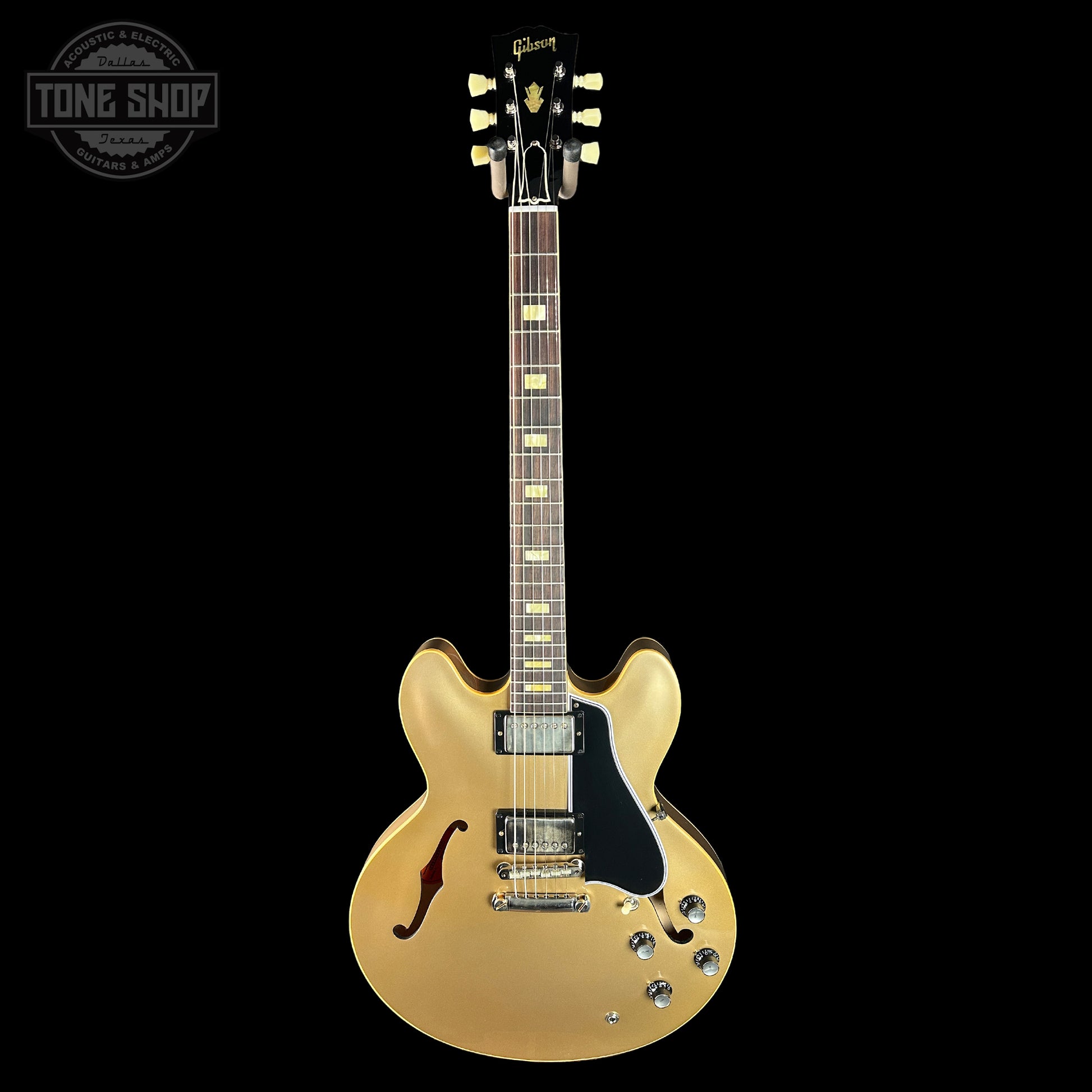 Gold electric guitar on a black background with 'Tone Shop' logo.
