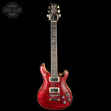 Red electric guitar on a black background with 'Tone Shop' logo.