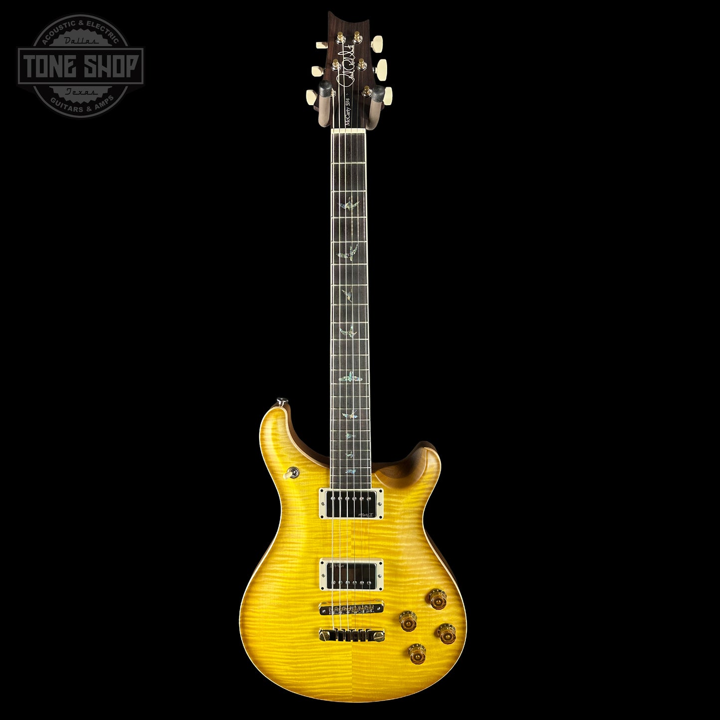 Yellow electric guitar on a black background with 'Tone Shop' logo.