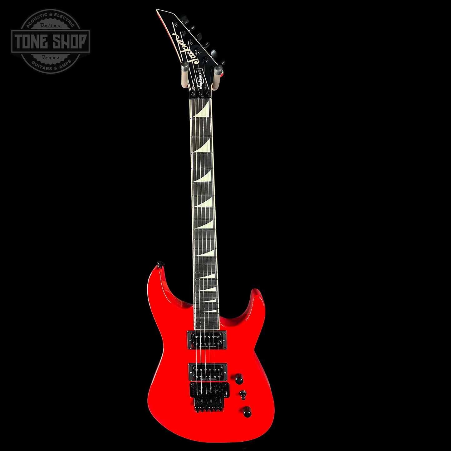 Red electric guitar on a black background with 'Tone Shop' logo.