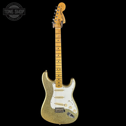 Gold glitter electric guitar with a white pickguard on a black background, featuring 'Tone Shop' logo.