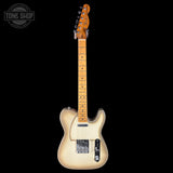 Electric guitar with a blonde finish on a black background, featuring the Tone Shop logo.