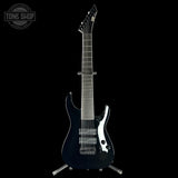 Black electric guitar on a stand with 'Tone Shop' logo in the corner.