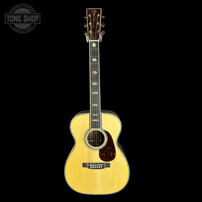Acoustic guitar with a visible brand logo on a black background