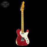 Red and white electric guitar with a visible brand logo on a black background