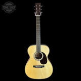 Acoustic guitar on a black background with 'Tone Shop' logo.