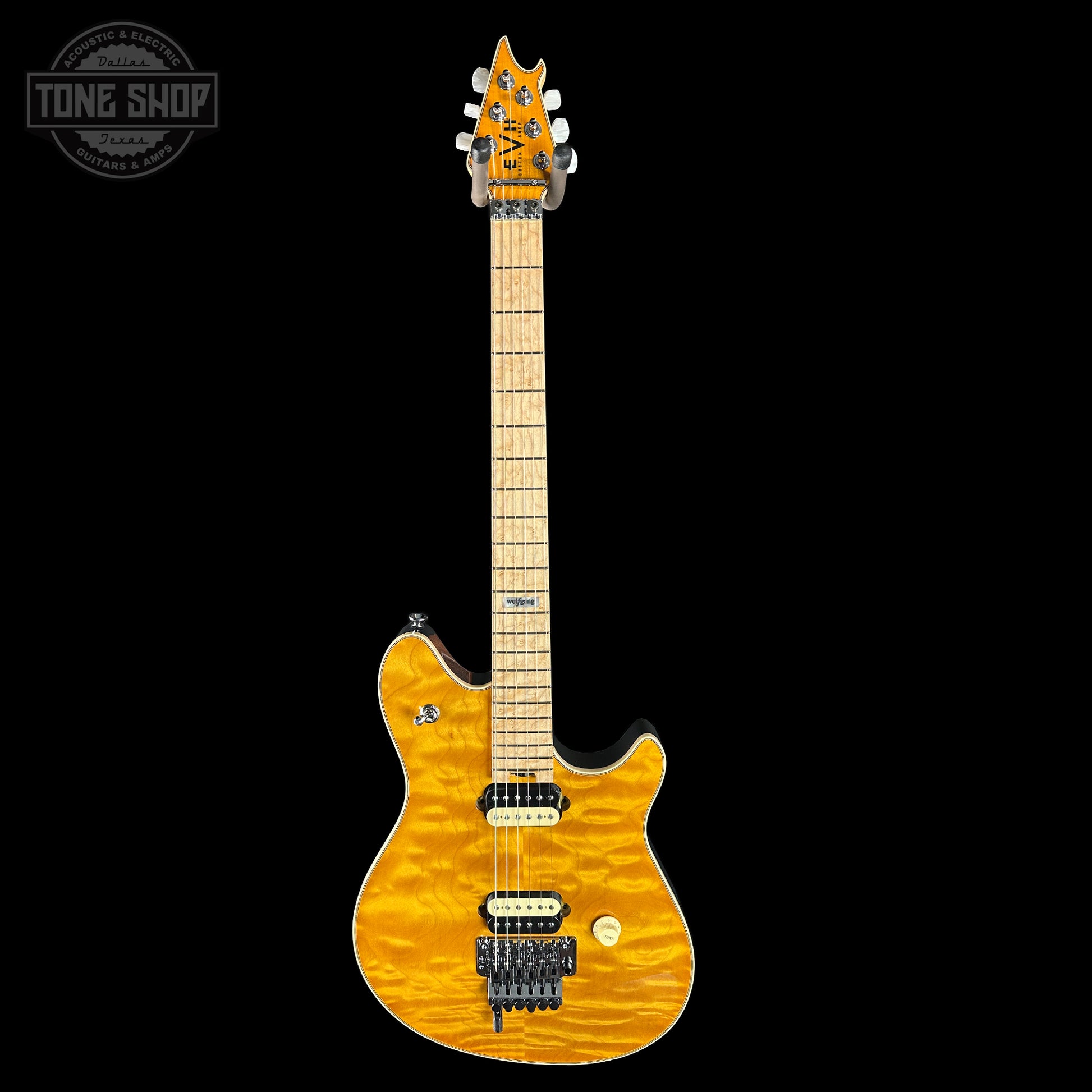 Electric guitar with a quilted maple top on a black background, featuring the EVH brand.