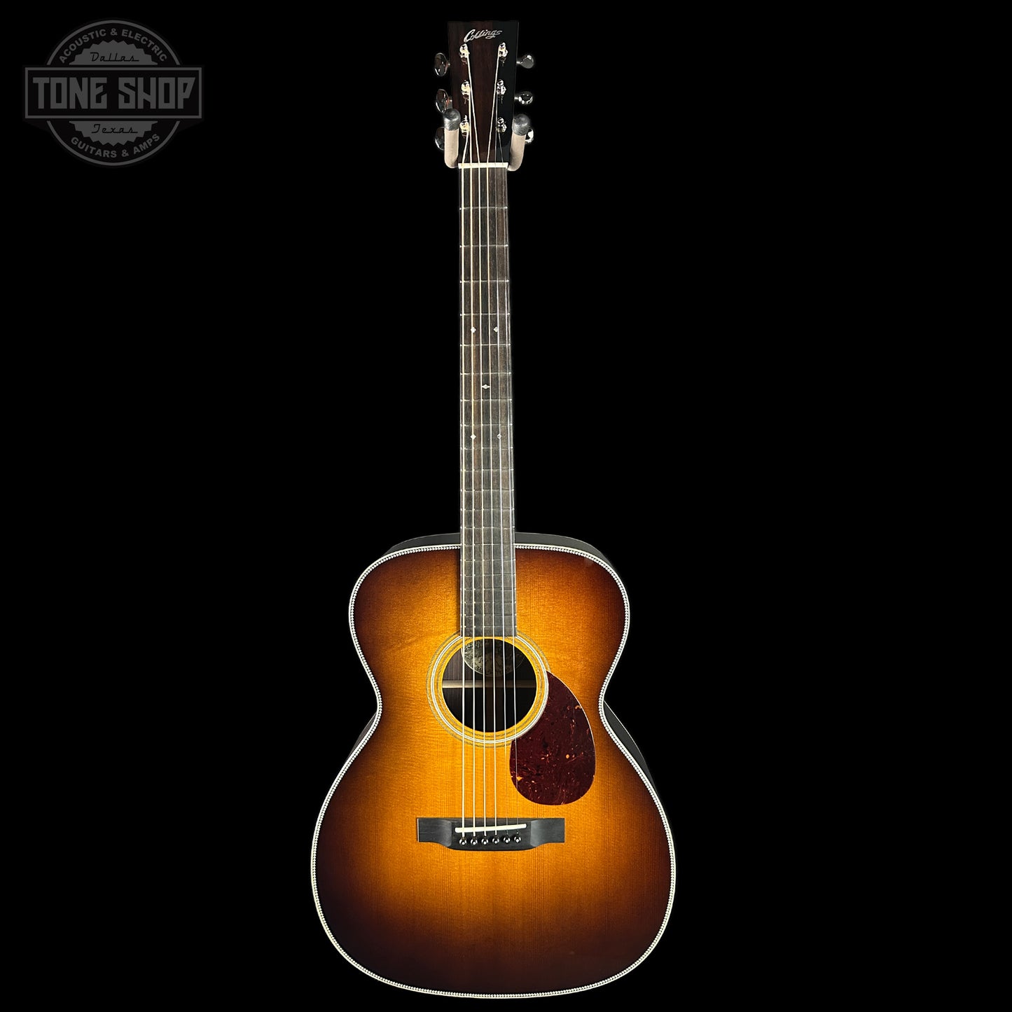 Acoustic guitar with a sunburst finish on a black background, featuring the Tone Shop logo.