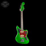 Green electric guitar with a red pickguard on a black background, featuring 'Tone Shop' logo.