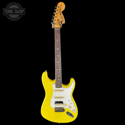 Yellow electric guitar with a white pickguard on a black background, featuring the Tone Shop logo.
