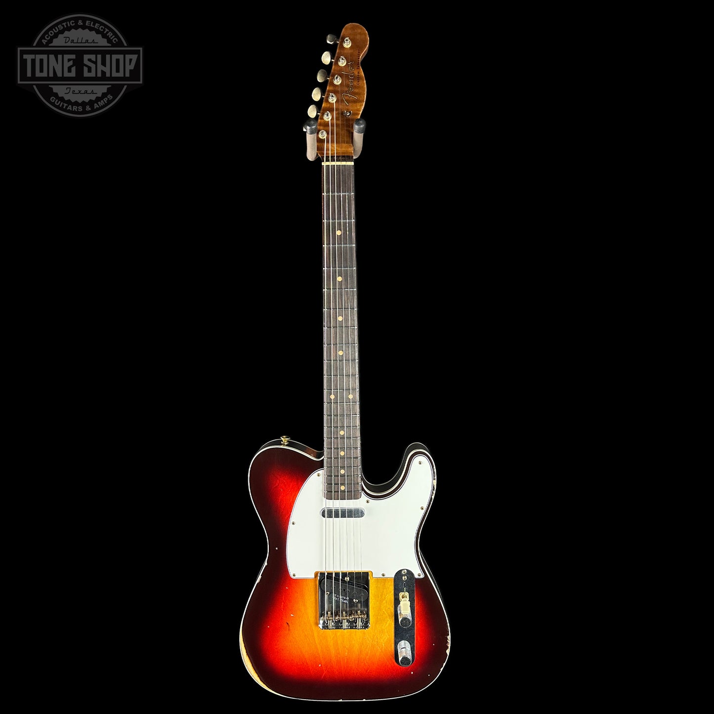 Electric guitar with a sunburst finish on a black background, featuring the Tone Shop logo.