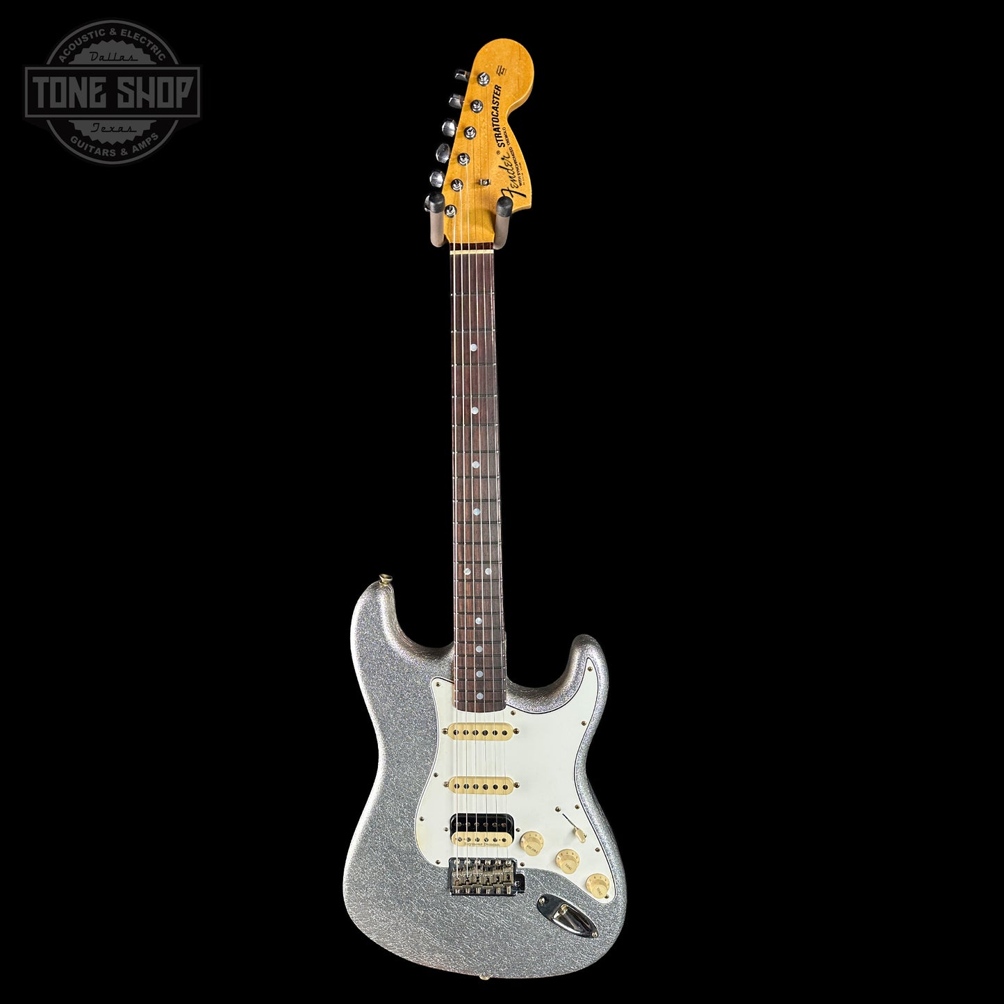 Silver electric guitar with a black background