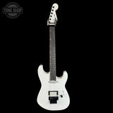 White electric guitar on a black background with 'Tone Shop' logo.